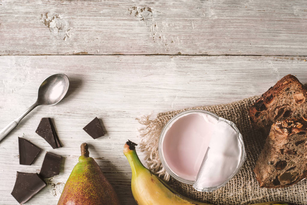 Berry farm yogurt in a jar, chocolate and fruits - Фото, изображение