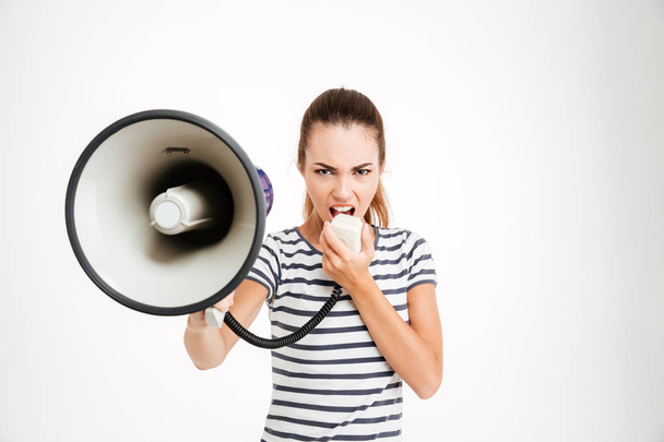 Beautiful woman shouting into megaphone - Фото, зображення