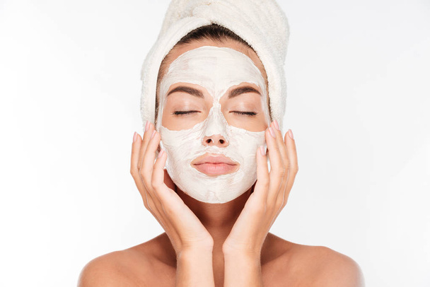 Woman with eyes closed and white facial mask on face - Foto, imagen