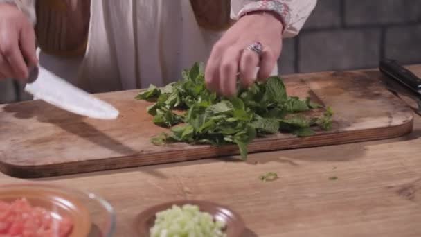Cutting greens on a cutting board - Кадри, відео
