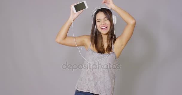 Woman singing along to her music - 映像、動画