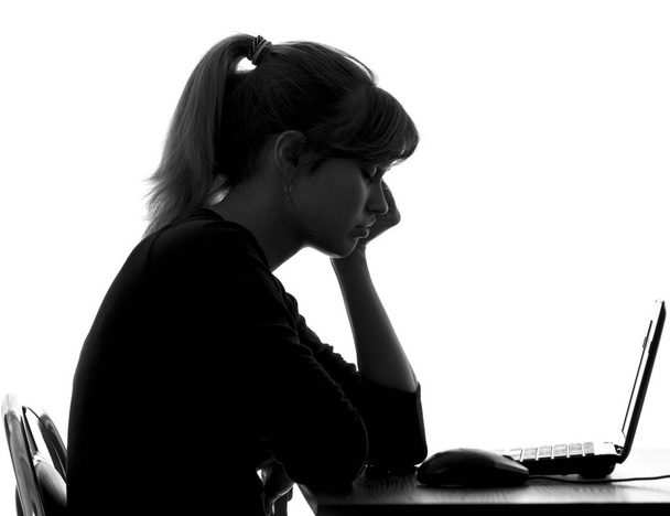 silhouette of a woman fallen asleep near netbook - Fotó, kép