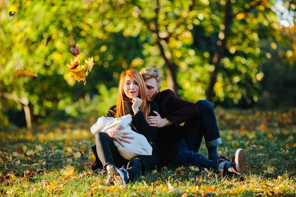 young family and newborn son in autumn park - Foto, Bild