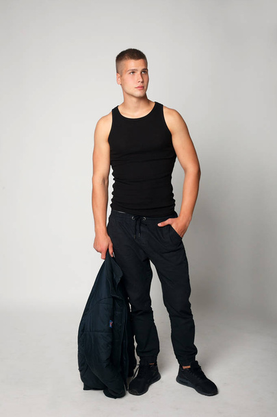 Expressive young stylish man in black t-shirt - Фото, зображення