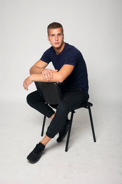 young fashion man sitting on a chair - Zdjęcie, obraz