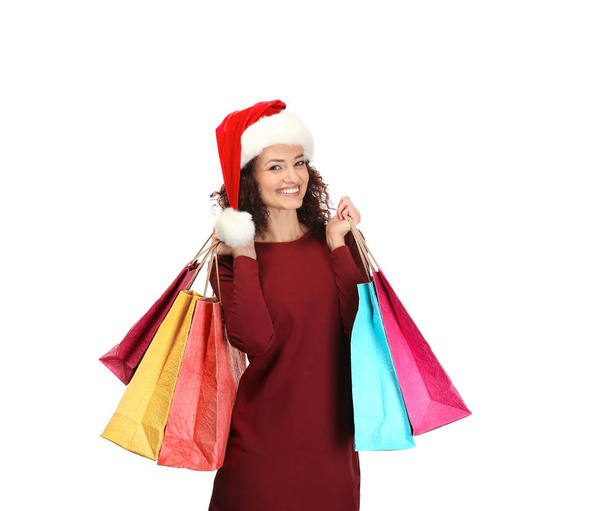 Happy woman holding shopping bags on white background. Christmas shopping concept - Fotoğraf, Görsel