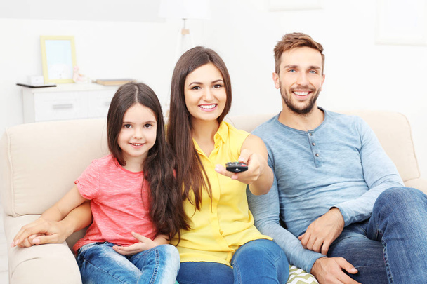 Happy family watching TV at home - Foto, immagini
