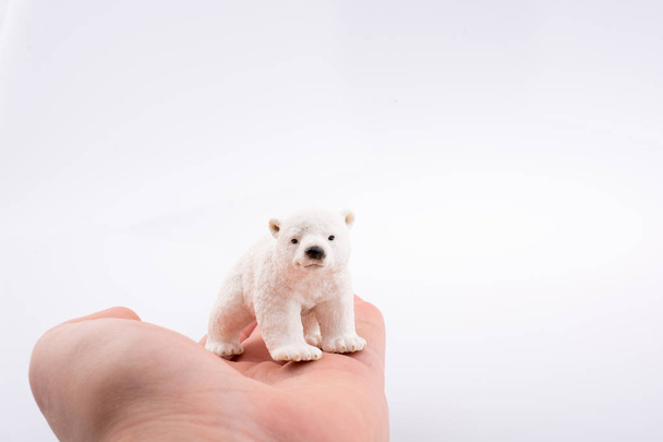 Hand holding a Polar Bear figure - Fotografie, Obrázek