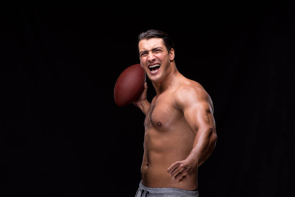 Ripped muscular man with american football - Fotoğraf, Görsel