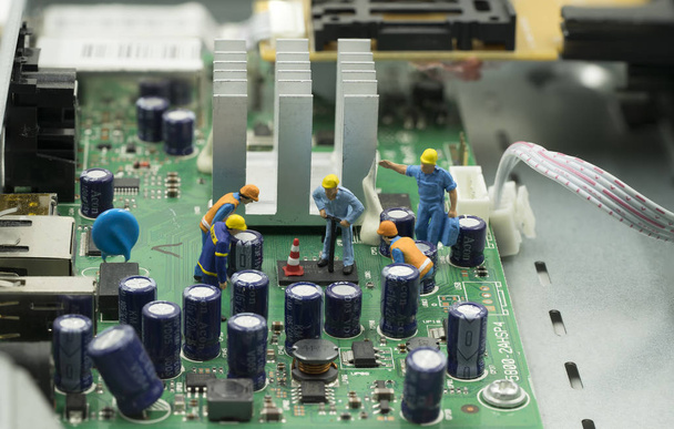 mini workers are working on mainboard to repair it - Photo, Image