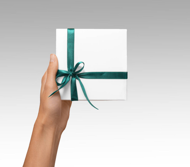 Isolated Woman Hands holding Holiday Present White Box with Blue Ribbon on a White Background - Photo, Image