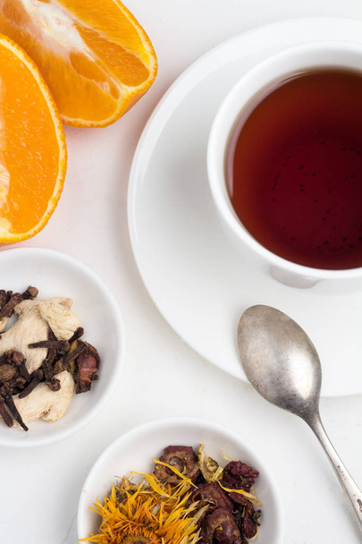 a mug of tea, oranges and sugar - Photo, Image