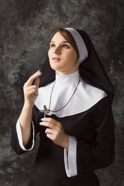 Religious nun in religion concept against dark background - Photo, Image