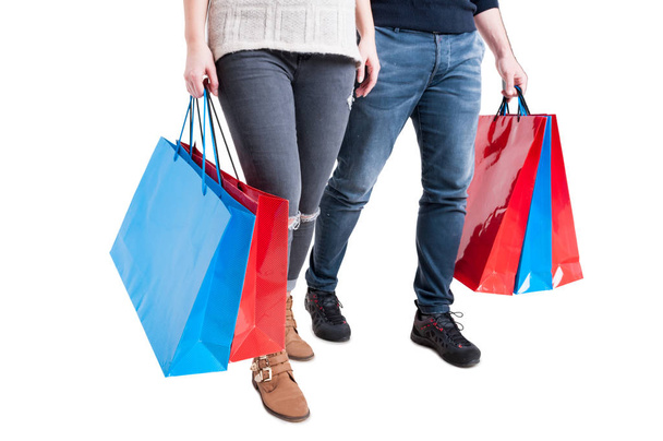 Couple holding bunch of shopping bags and walking - Foto, imagen