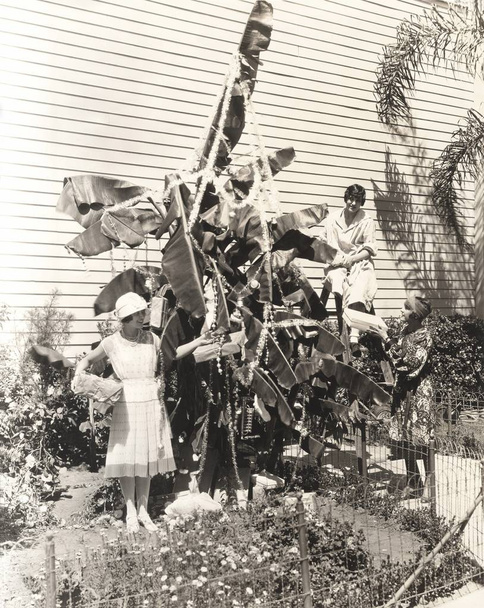 Friends decorating banana tree - Photo, Image