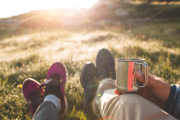 couple in mountains drinking hot coffee or tea  - Photo, Image