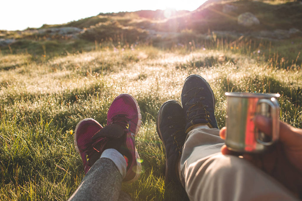 couple in mountains drinking hot coffee or tea  - Photo, Image