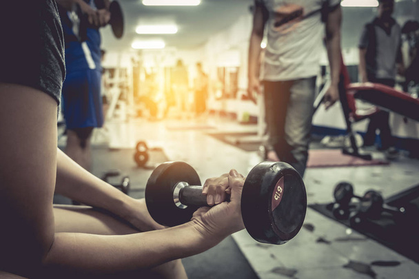 Healthy woman with dumbbell in gym. vintage. - Photo, Image