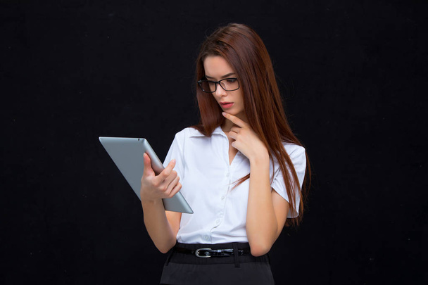 The young business woman with tablet on black background - Foto, Imagem