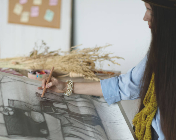 Young female painter painting in her studio.  - Valokuva, kuva
