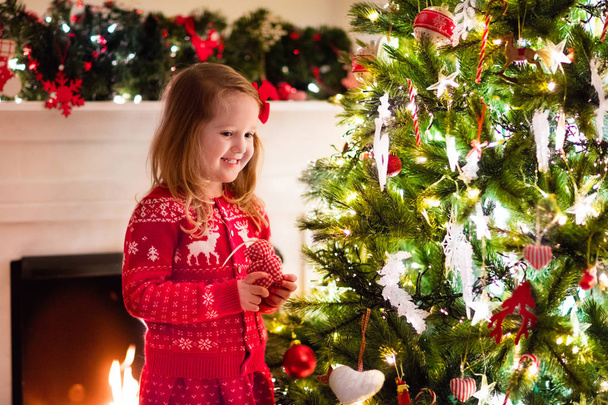 Child decorating Christmas tree - Foto, imagen