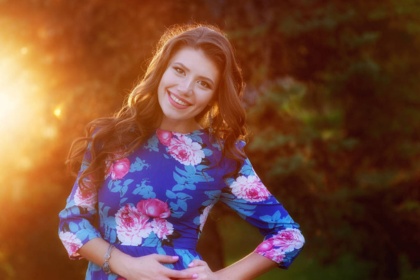 happy young woman posing in the Park against sunset - Photo, Image