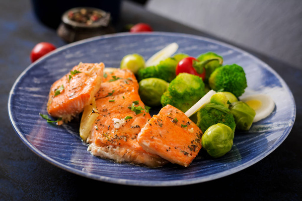 Baked salmon with broccoli in blue plate - Photo, Image
