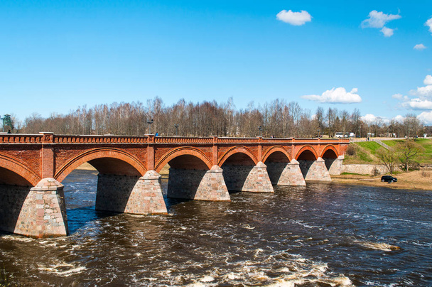 Old orange brick bridge over river Venta in Kuldiga town, Latvia - Photo, Image