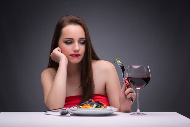 Beautiful woman eating alone with wine - Photo, Image