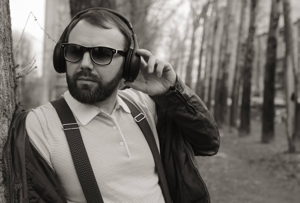monochrome beard man listen music in park - Photo, Image