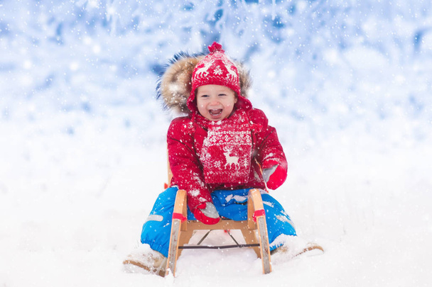 Les enfants jouent dans la neige. Randonnée en traîneau d'hiver pour enfants
 - Photo, image