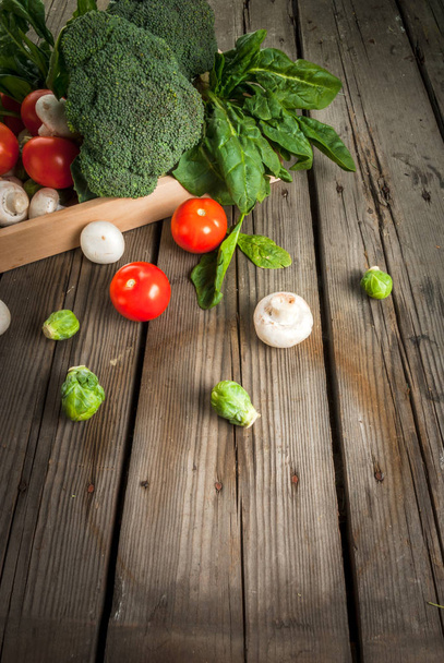 Fresh raw organic vegetables on a rustic wooden table in basket: - Fotoğraf, Görsel