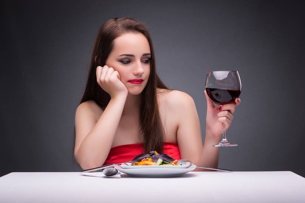 Beautiful woman eating alone with wine - 写真・画像