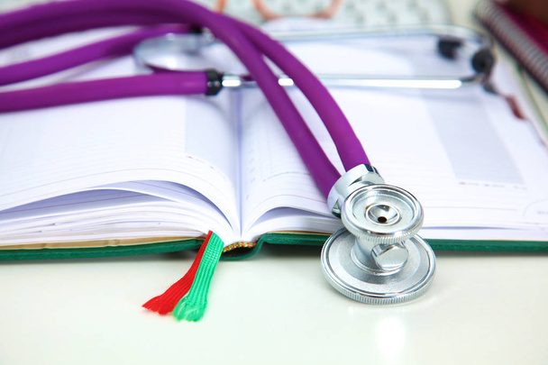 Stethoscope lying on a table an open book - Photo, Image