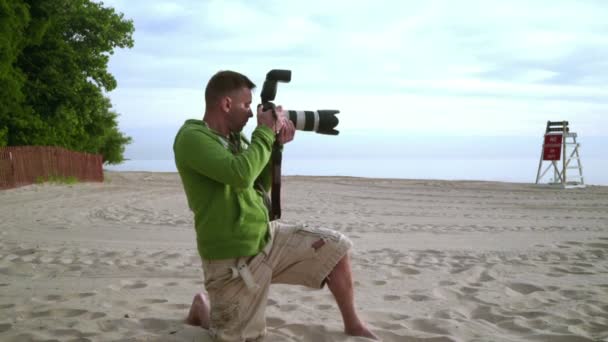 Photographer takes photo on sea beach. Photographer working - Footage, Video