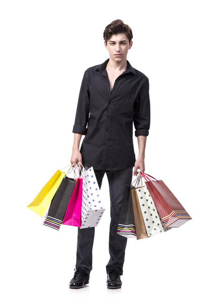 Young man in shopping concept isolated on white - Foto, Imagen