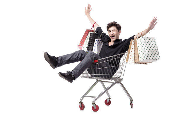 Young man with shopping cart and bags isolated on white - Foto, afbeelding