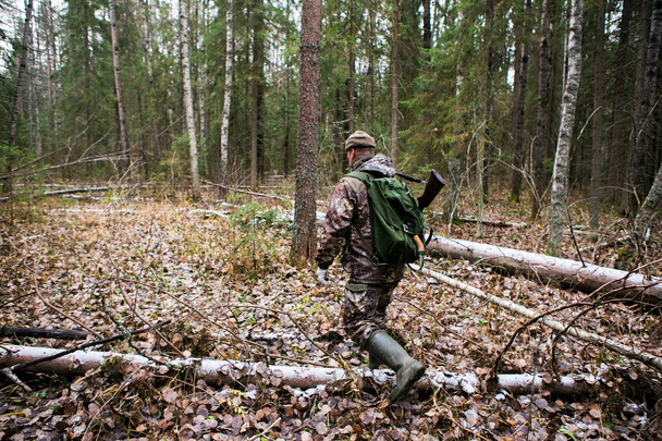 Hunter walking through forest - Foto, Imagem