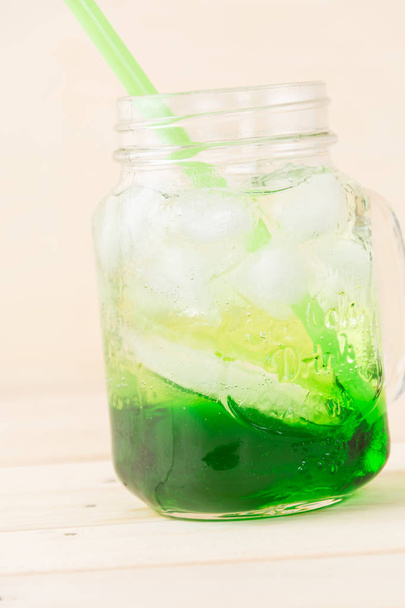 green soda on wood background - Zdjęcie, obraz