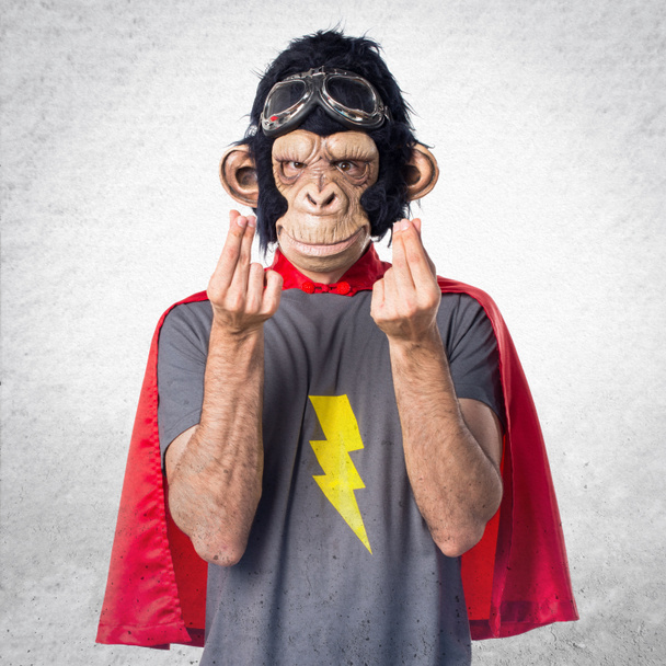Szuperhős majom-ember csinál pénzt gesztus - Fotó, kép