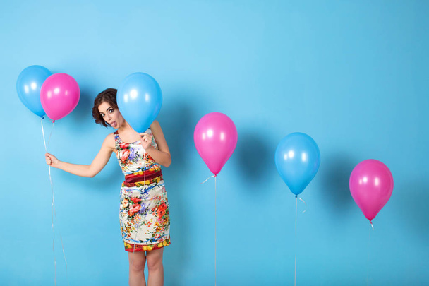 Funny Woman with helium balloons. - Zdjęcie, obraz