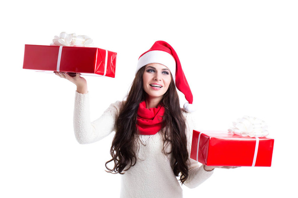 Beautiful woman in santa hat holding two gifts. - Фото, зображення