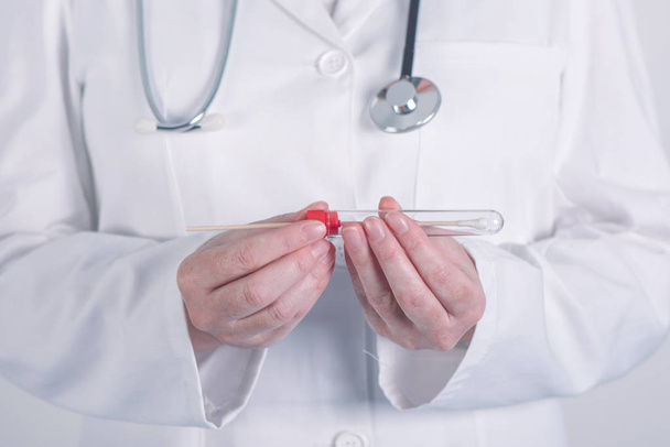 Female doctor preparing test tube for biological specimen - Фото, изображение