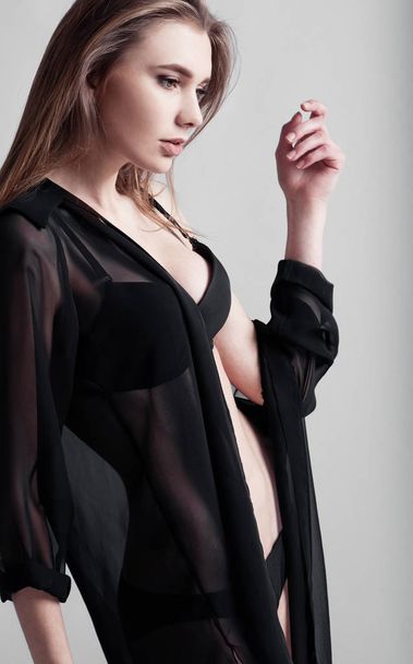 Beautiful sexy woman with black lingerie on grey - Fotó, kép