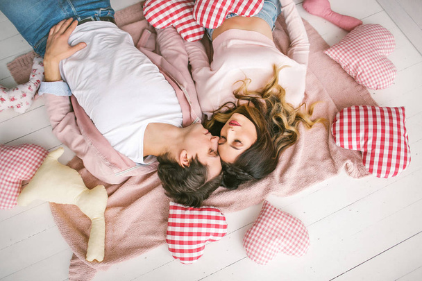 Happy couple in love lying on floor in studio - Valokuva, kuva