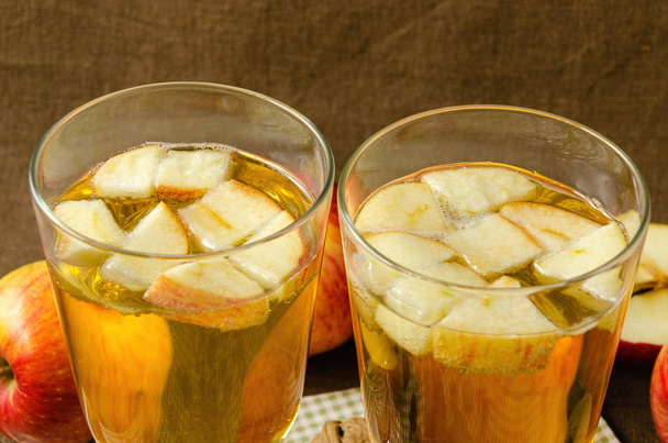 Hot apple cider with apples and slices in cups - Fotó, kép