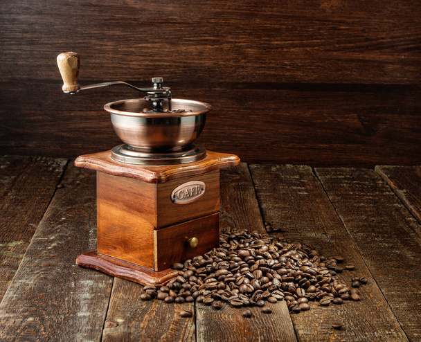 Coffee mill on old rustic background. Wood texture - Foto, Bild