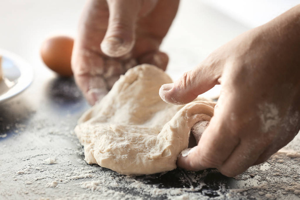Male hands making fresh dough  - Foto, imagen