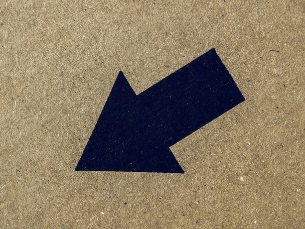 Vintage looking Black arrow on cardboard - Photo, Image
