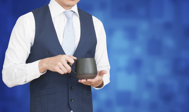 Business man holding cup of coffee. - Foto, Imagen